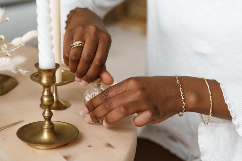 woman's hands display tuscany gold rings and bracelets